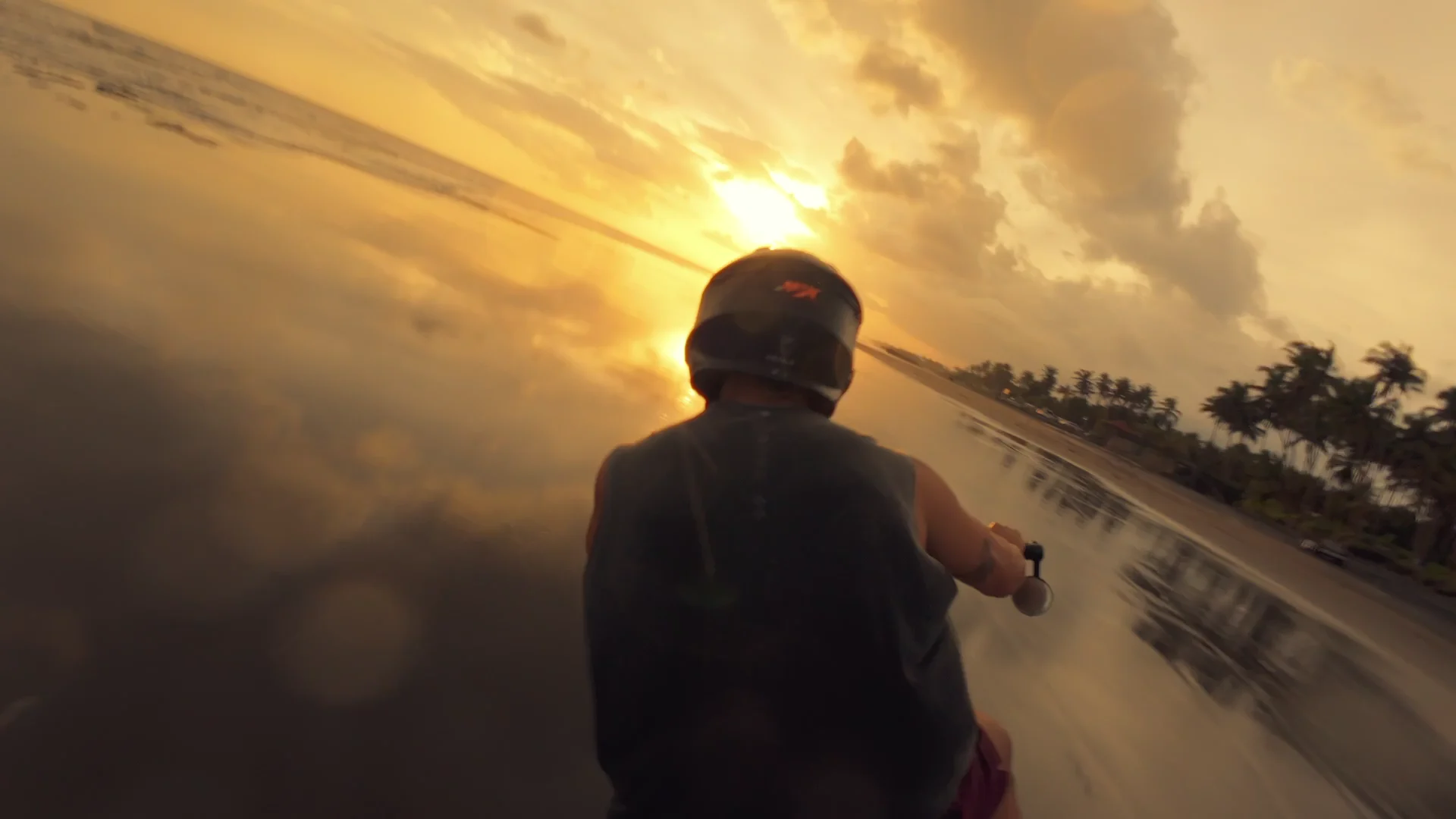 An action-camera edit of a motorcycle ride through sunset reflections at Pasut.